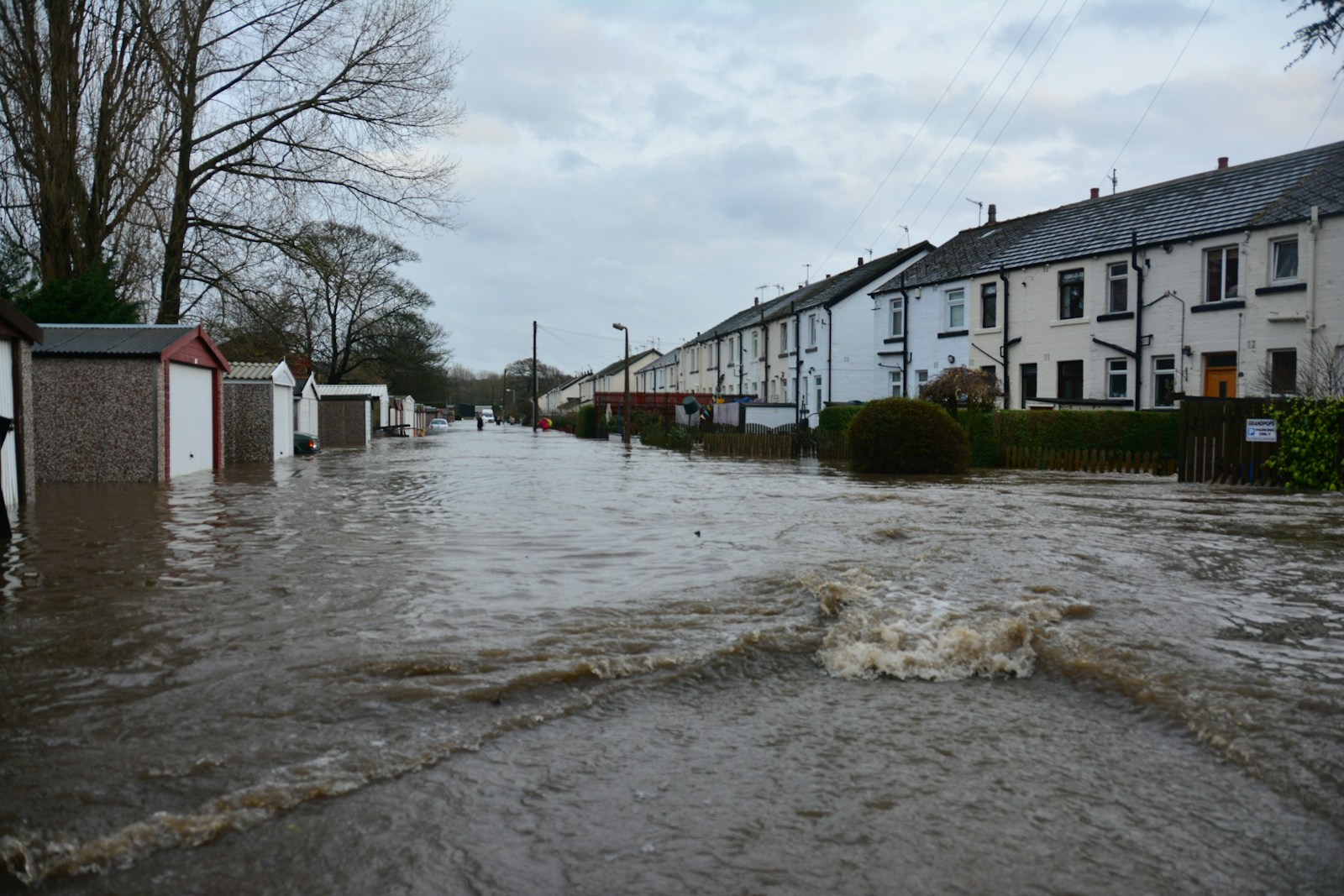 white and brown concrete building near body of water during daytime flood